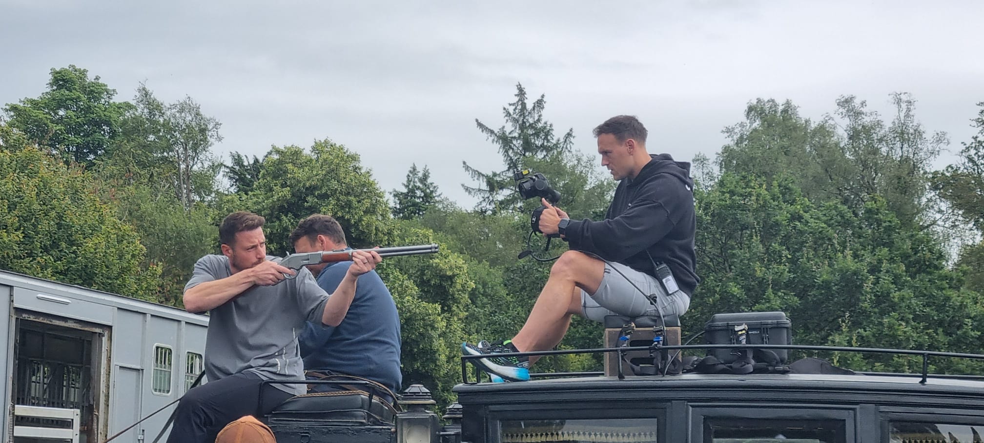 Adam Brashaw filming a Young Sherlock action rehearsal from above a vehicle.